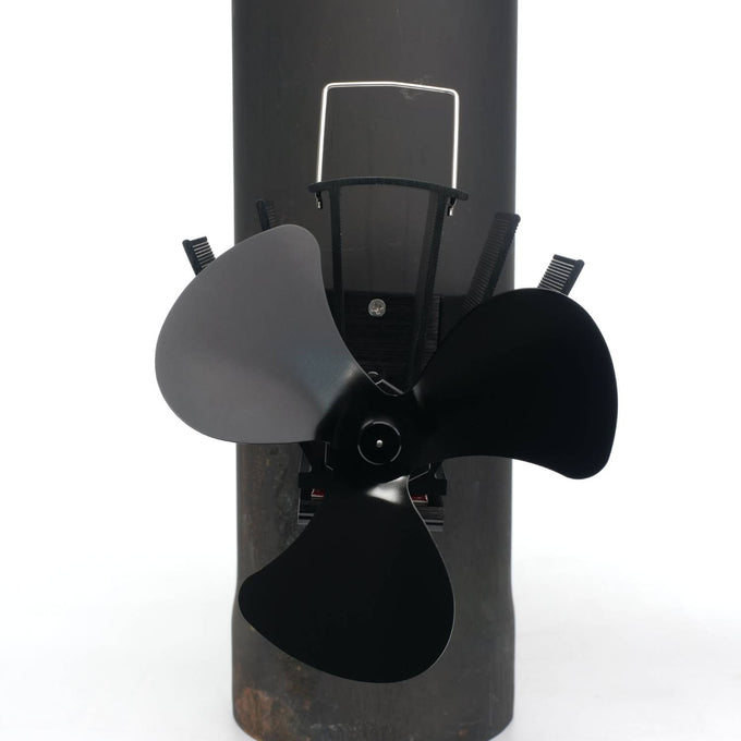 Three-bladed black magnetic fan mounted on a stove flue pipe with metal fins, designed to circulate warm air efficiently in hearths, featured in Stoves, Hearth Accessories, Best Sellers, and Promo Eligible collections.