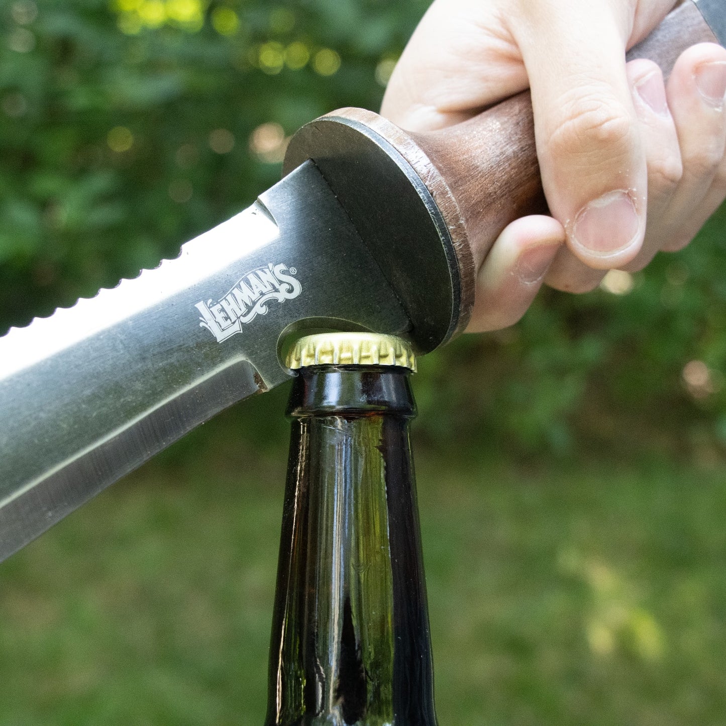 Hand gripping a wooden-handled garden knife with a steel blade used to open a bottle cap outdoors, highlighting durability and multi-functionality in Farm, Garden & Tool collections.