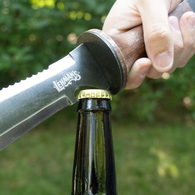 Hand gripping a wooden-handled garden knife with a steel blade used to open a bottle cap outdoors, highlighting durability and multi-functionality in Farm, Garden & Tool collections.