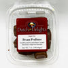 Clear plastic container of sugar-free pecan pralines made with freshly roasted pecans and buttery caramel coated in sugar-free chocolate, ideal for Kitchen & Food, Snacks and Sweets, Candy, USA Made, Best Sellers, and Promo Eligible collections.