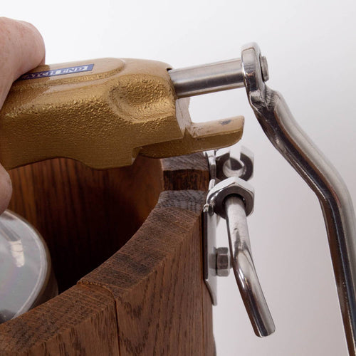 Close-up of a hand turning the rugged metal crank handle attached to a handcrafted wooden ice cream freezer bucket, showcasing durable construction in Kitchen & Food and Specialty Equipment collections.