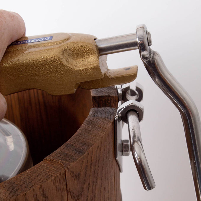 Close-up of a hand turning the rugged metal crank handle attached to a handcrafted wooden ice cream freezer bucket, showcasing durable construction in Kitchen & Food and Specialty Equipment collections.