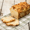 Loaf of handcrafted fresh pepperoni bread with melted cheese, sliced on a green and white checkered cloth, representing USA Made and Kitchen & Food collections.