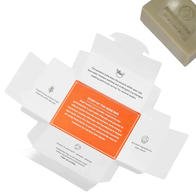Open soap packaging with detailed text highlighting Ayurvedic tradition, ancient natural ingredients, and sustainable care for skin and environment, accompanied by a handcrafted soap bar rich in organic coconut oil, featured in Health & Wellness, Soaps, Best Sellers, and Promo Eligible collections.