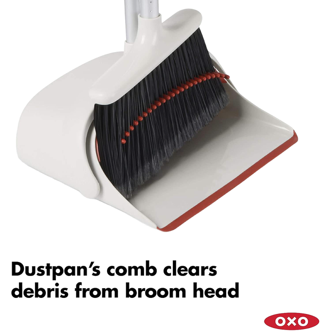 Extra-large dustpan with comb edge removing debris from black flagged bristles on an extendable broom, designed for efficient cleaning in Home & Decor and Household Cleaning collections.