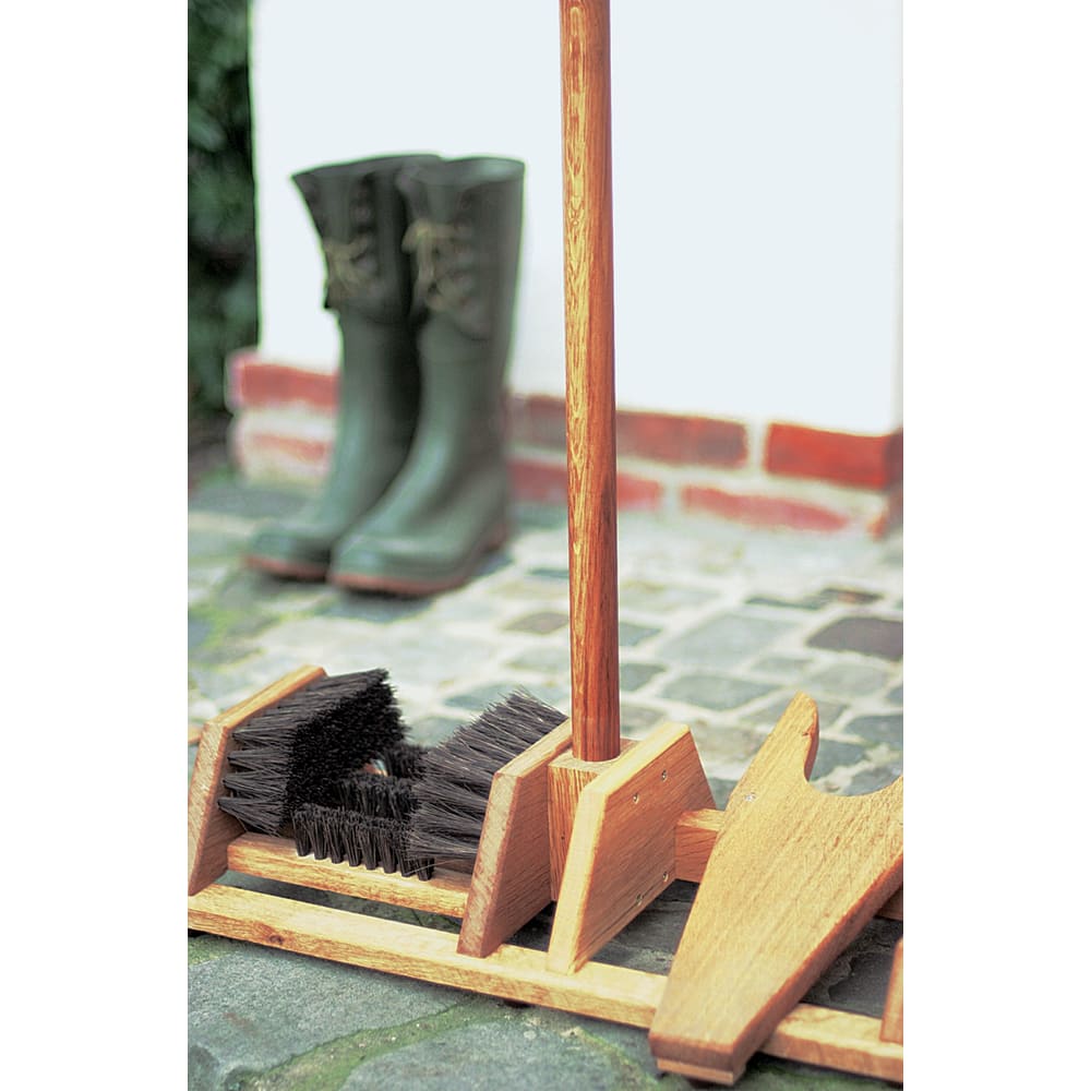 Handcrafted oak bootscraper with durable arenga bristles and built-in bootjack, designed for easy cleaning of muddy boots while standing, ideal for Health & Wellness and Home & Decor collections.