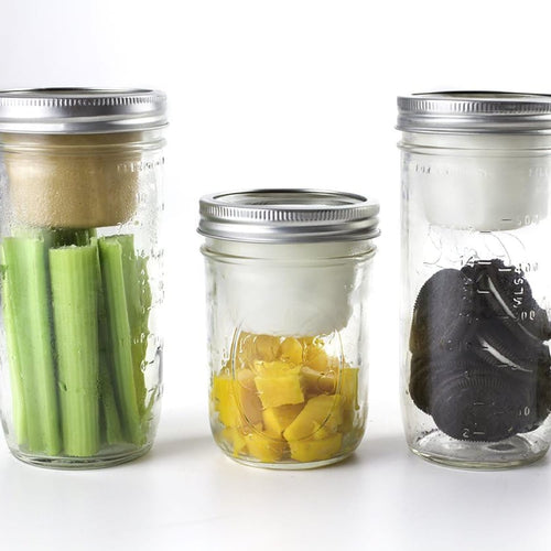 Three clear glass wide-mouth jars with metal lids, each fitted with a white divider cup separating fresh celery, pineapple chunks, and black olives, ideal for Kitchen & Food, Kitchen Gadgets, Storage and Serving, USA Made, and Best Sellers collections.