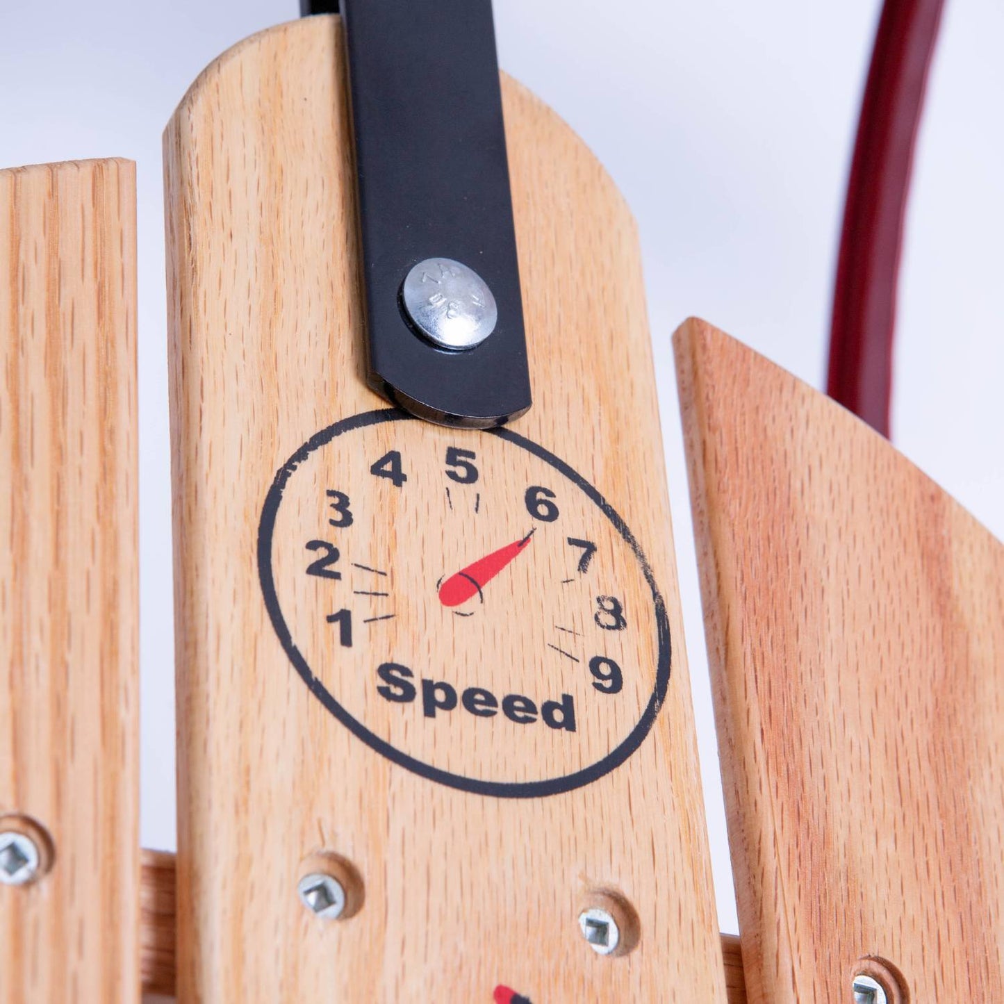 Close-up of a handcrafted wooden sled panel featuring a speedometer-style decal with numbers and a red needle pointing to six, showcasing quality wood and metal hardware in USA Made Children's Toys and Outdoor Play collections.
