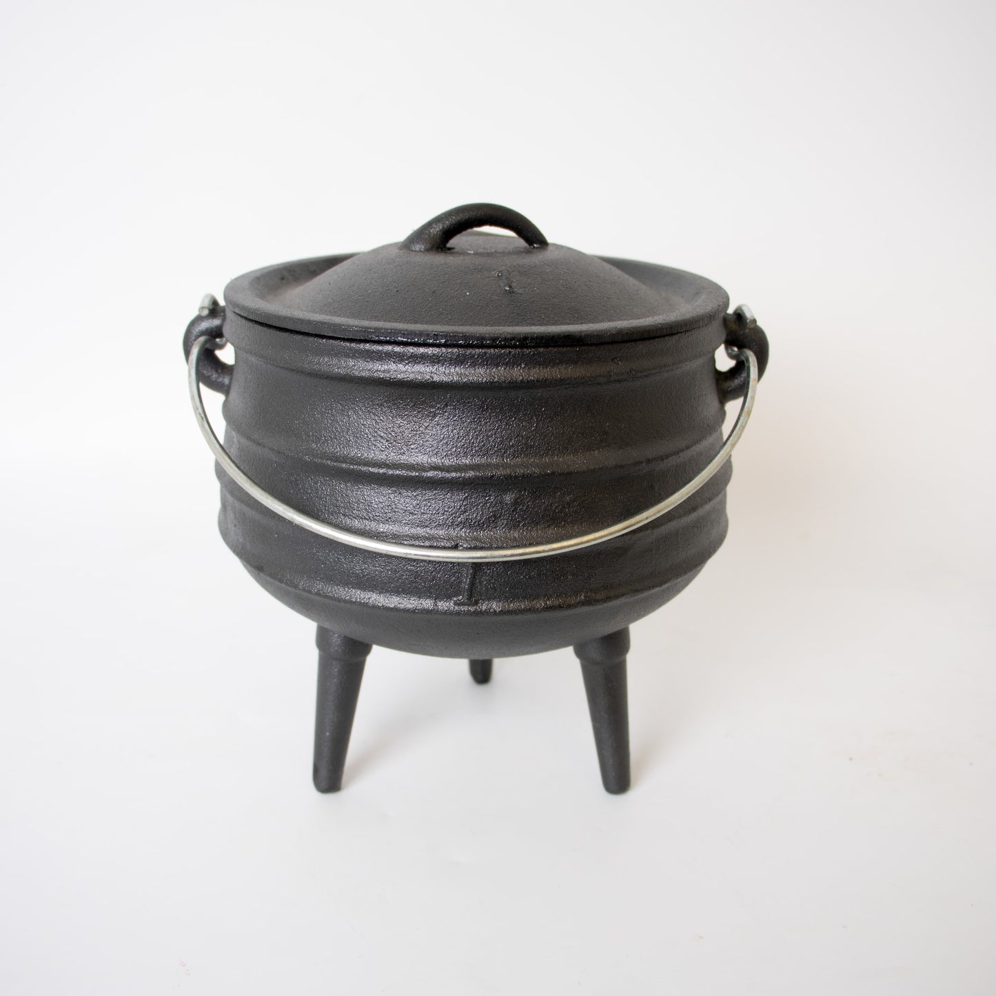 Handcrafted cast iron campfire kettle with round shape, sturdy metal bail handle, and three legs, designed for durable outdoor cooking in Farm, Garden & Tool, Camping, Best Sellers, and Promo Eligible collections.