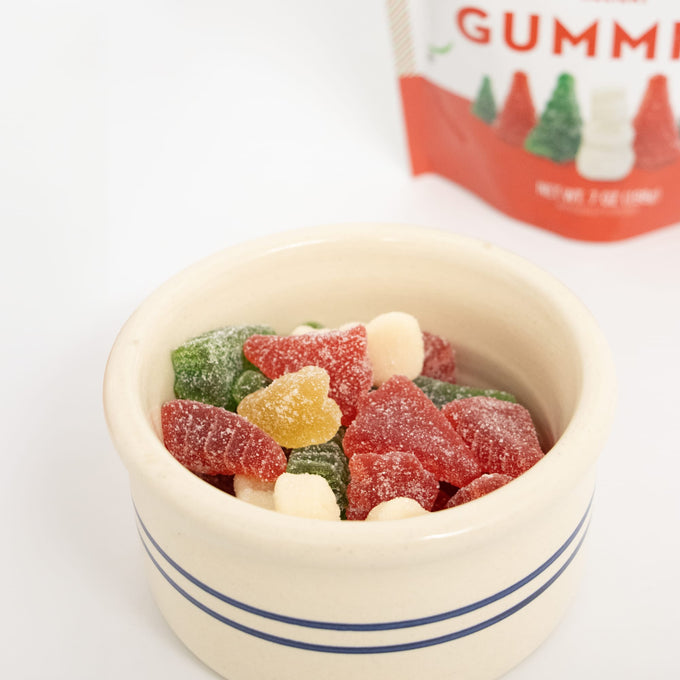 Handmade red, green, and white sugar-coated Christmas gummies shaped like trees and snowmen in a cream ceramic bowl, part of Kitchen & Food, Candy, USA Made, and Best Sellers collections.