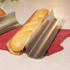 Set of two heavy gauge tinplate steel pans designed for baking crusty European-style bread, displayed on a red patterned cloth, ideal for Kitchen & Food, Cookware, and Baking Supplies collections.