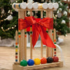 Handcrafted Amish wooden croquet set with solid maple mallets and colorful balls, displayed with a festive red bow, ideal for outdoor play, children's toys, and lawn games collections.