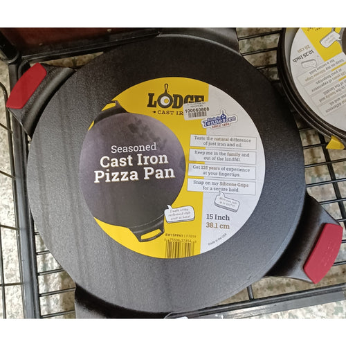 Seasoned cast iron pizza pan with dual handles featuring red silicone grips, rimless for edge-to-edge baking, handcrafted in the USA, ideal for Kitchen & Food, Cookware, Cast Iron, and Best Sellers collections.