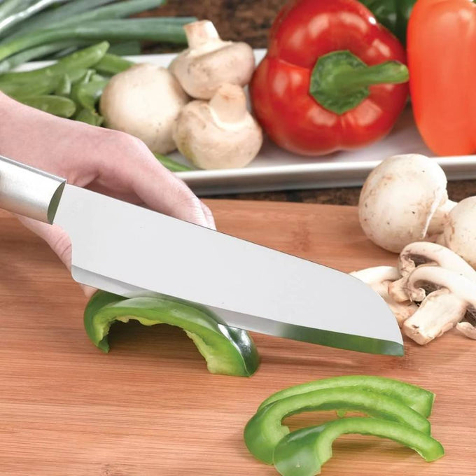 Handcrafted stainless steel cook's knife slicing a green bell pepper on a wooden cutting board, surrounded by fresh vegetables, ideal for Kitchen & Food and USA Made collections.
