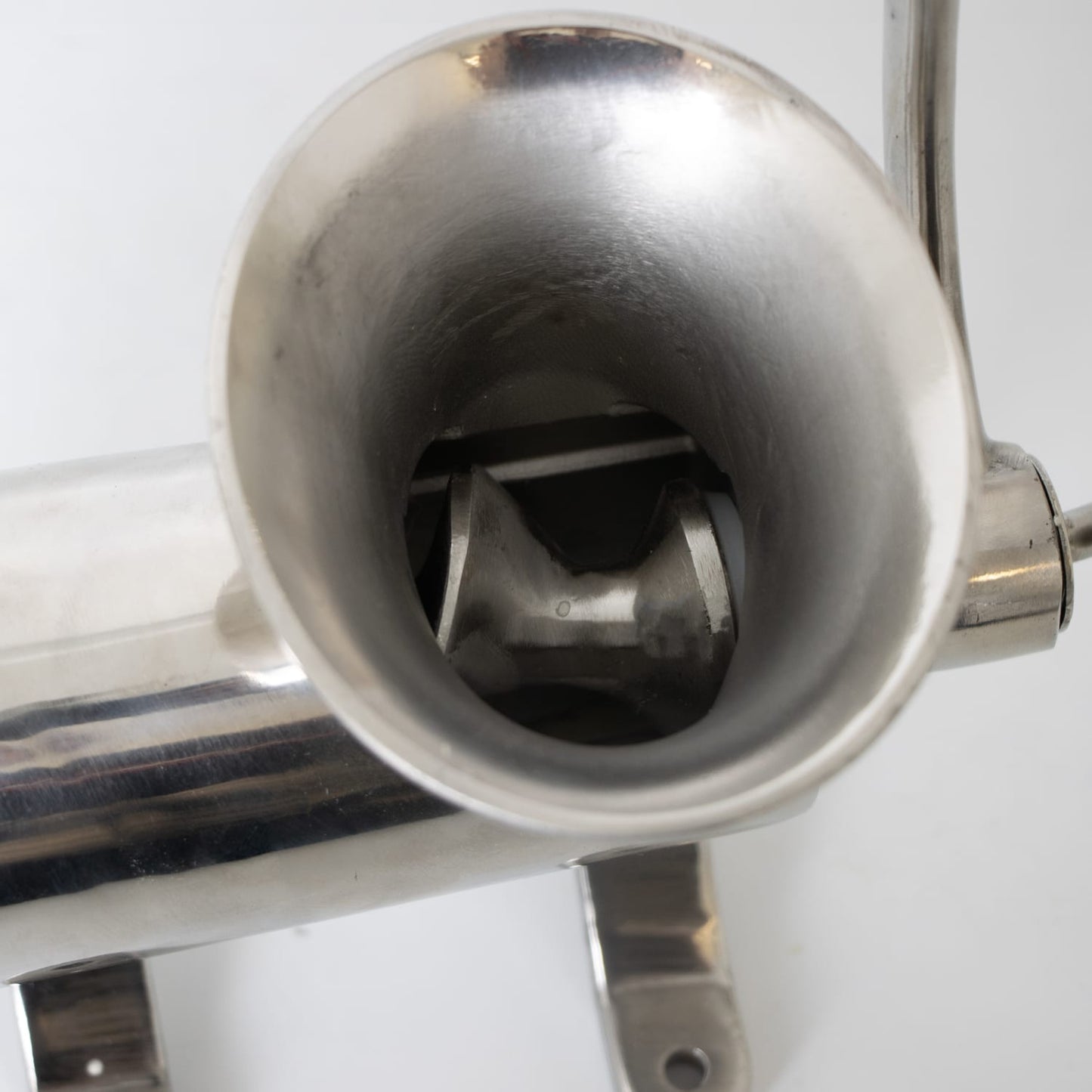 Close-up view inside the stainless steel meat grinder hopper showing the spiral auger, handcrafted and featured in Kitchen & Food, Specialty Equipment, Butchering Supplies, and Best Sellers collections.