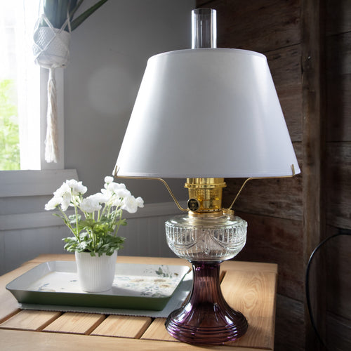 Classic white parchment lamp shade designed for a 14-inch tripod oil lamp, displayed in a cozy rustic setting, ideal for Lamps & Lighting and Lamp Shades collections.