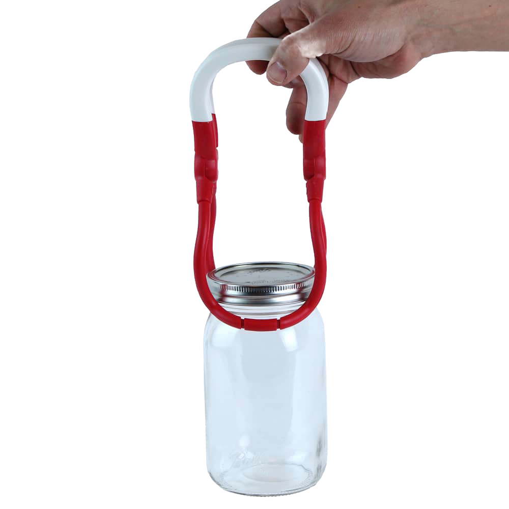 Hand holding a one-handed jar lifter with a red and white rounded handle gripping a glass canning jar, designed for safe lifting in kitchen, canning, and food preservation tasks.