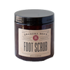 Amber glass jar of handcrafted foot scrub with a simple beige label, made in USA, ideal for Health & Wellness, Balms, Creams and Lotions, and Best Sellers collections.