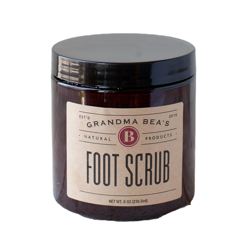 Amber glass jar of handcrafted foot scrub with a simple beige label, made in USA, ideal for Health & Wellness, Balms, Creams and Lotions, and Best Sellers collections.