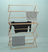 Handcrafted small wooden floor clothes dryer with multiple tiers holding a black sweater and two checkered cloths, featured in Home & Decor and Laundry Supplies collections.