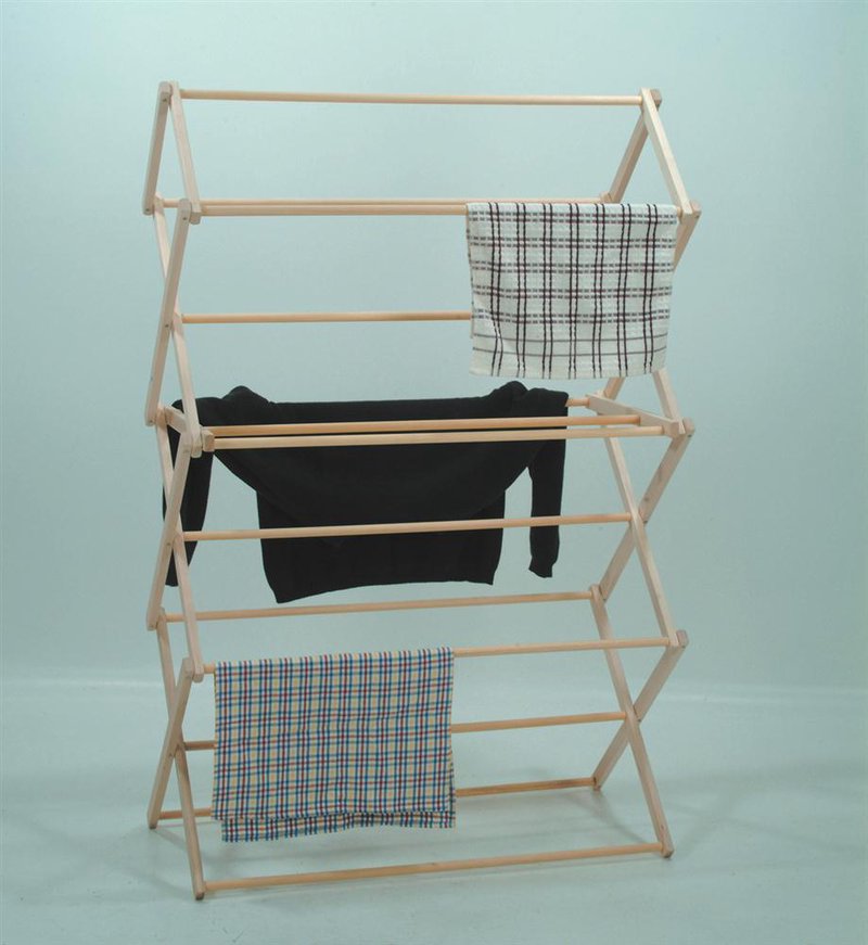 Handcrafted small wooden floor clothes dryer with multiple tiers holding a black sweater and two checkered cloths, featured in Home & Decor and Laundry Supplies collections.