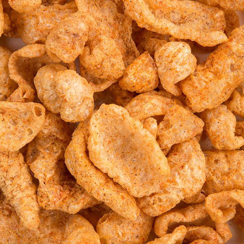 Close-up of seasoned pork rinds showcasing their crispy, airy texture, highlighting a handcrafted, USA-made snack popular in Kitchen & Food, Snacks and Sweets, and Best Sellers collections.