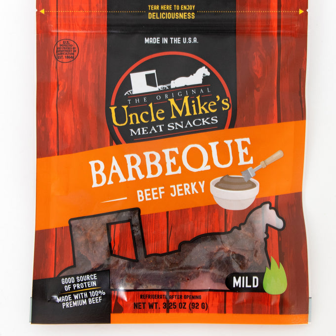 Resealable bag of mild barbecue flavored beef jerky in orange and red packaging with a clear window, highlighting a handcrafted, protein-rich snack made in USA for Kitchen & Food, Snacks and Sweets, Meats, USA Made, Best Sellers, and Promo Eligible collections.
