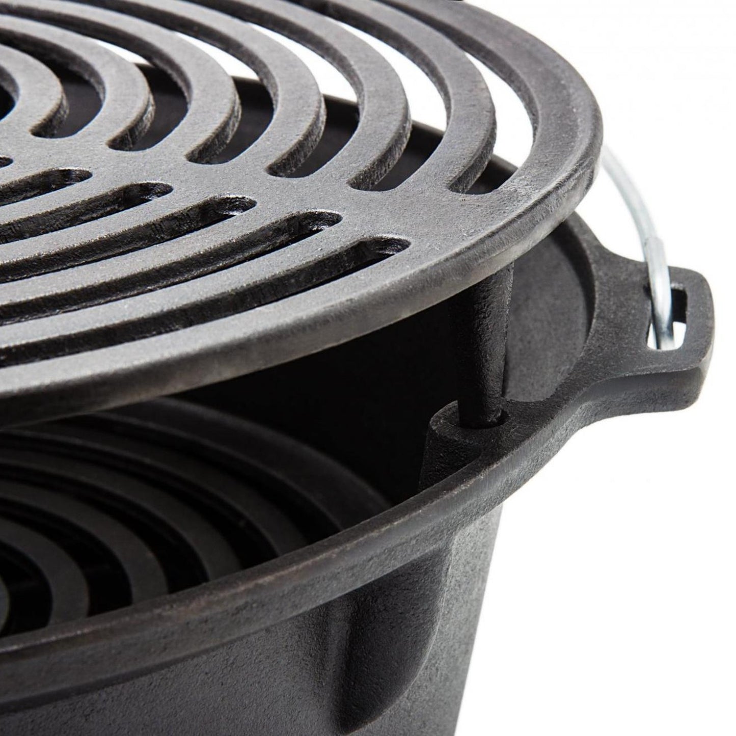 Close-up of a durable cast iron grill with adjustable grate and sturdy handle, designed for outdoor cooking in Farm, Garden & Tool, Stoves, Camping, Grilling, and Best Sellers collections.