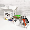 Stainless steel pressure canner with pressure gauge and black handle, shown with lid off and packing box in background, ideal for food preservation and kitchen use, made in USA.