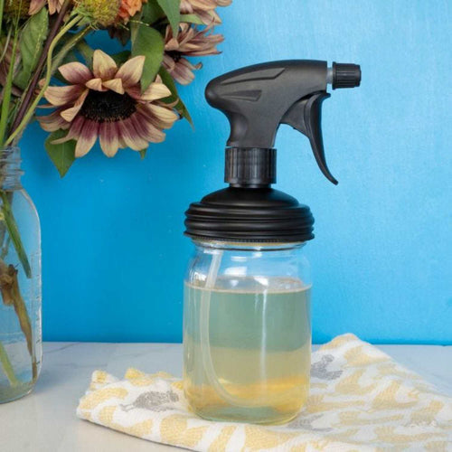 Regular-mouth glass jar fitted with a durable black sprayer lid with adjustable nozzle and trigger, displayed with decorative sunflowers, perfect for Home & Decor, Household Helpers, USA Made collections.