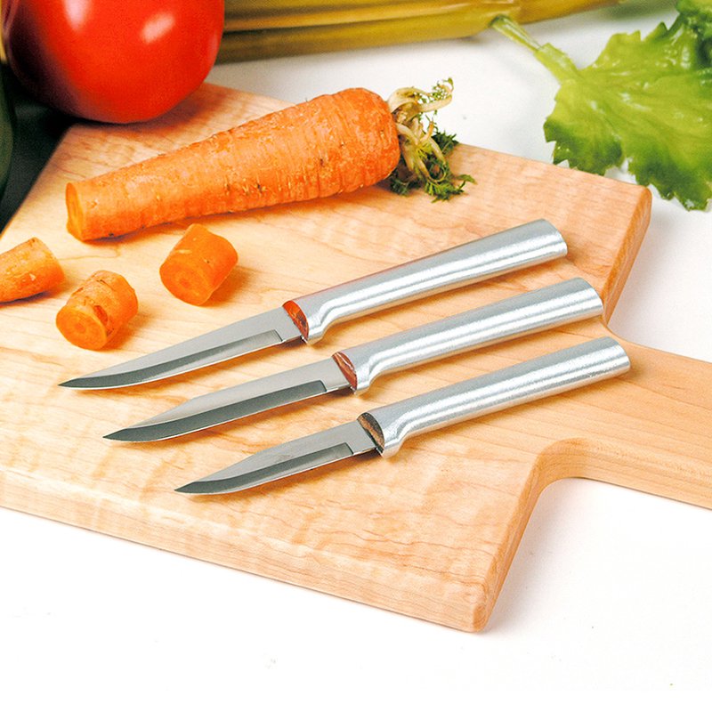 Set of three sharp paring knives with sleek cast aluminum handles featuring a non-slip satin finish, displayed on a wooden board with fresh carrot, tomato, and lettuce, ideal for kitchen food prep in USA made and best sellers collections.
