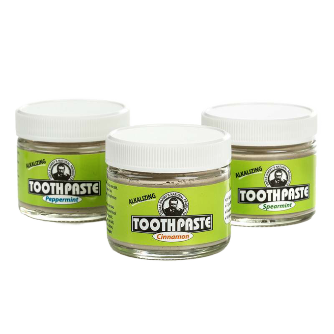 Three small glass jars of handcrafted all-natural alkalizing toothpaste in peppermint, cinnamon, and spearmint flavors with white lids, featured in Health & Wellness, Grooming and Personal Hygiene, USA Made, and Best Sellers collections.