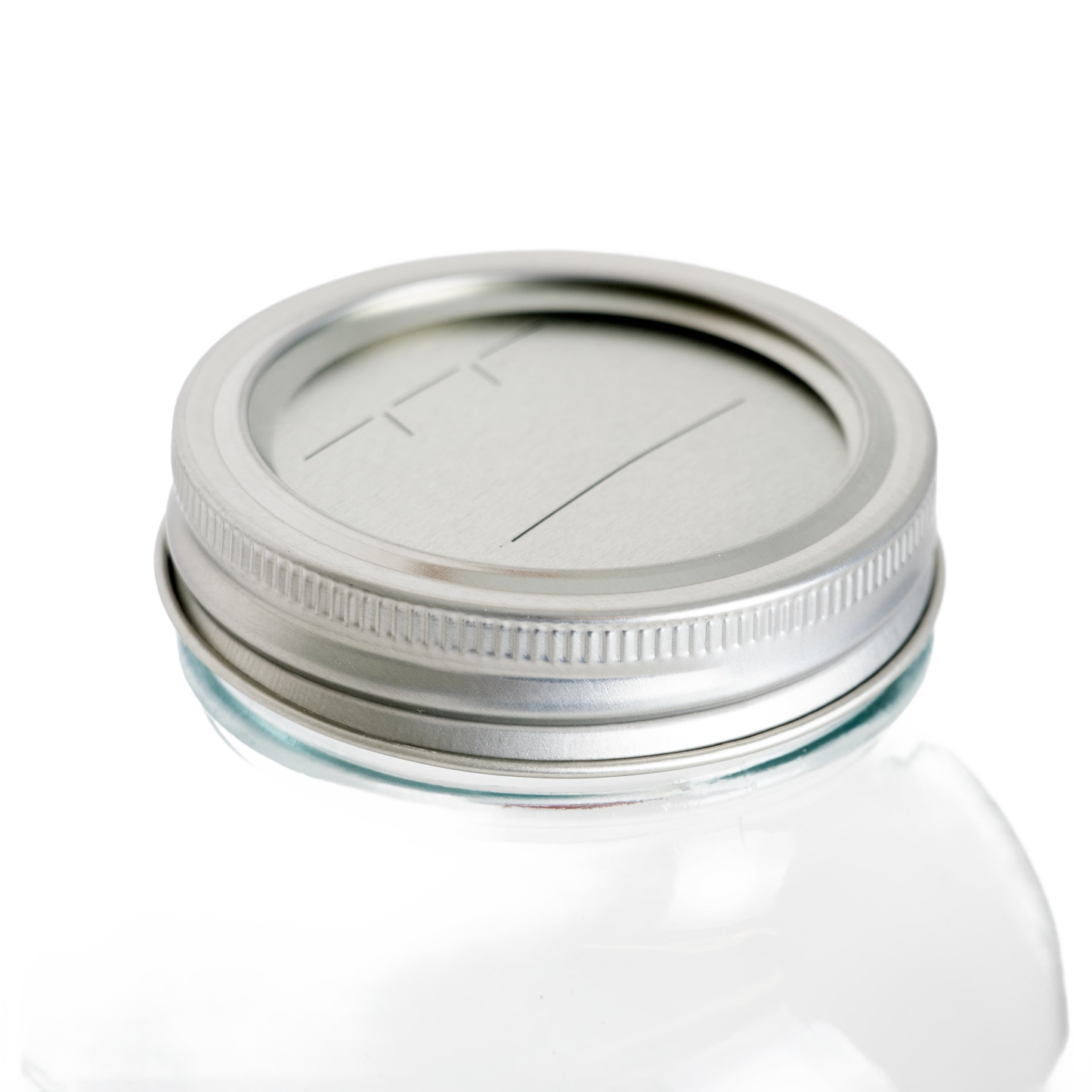 Silver-colored metal jar lid and band with BPA-free sealing compound, designed for regular-mouth glass jars, ideal for kitchen food preservation and canning collections.