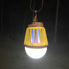 Rechargeable yellow and brown outdoor lantern glowing with bright white light and ultraviolet LED, designed for pest control, camping, and emergency use in outdoor settings.