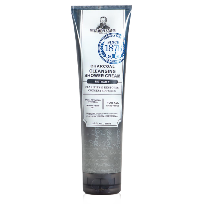 Tall gray and white tube of charcoal cleansing shower cream featuring detoxifying formula with steam-activated charcoal and organic hemp oil, from USA made health and wellness collection.
