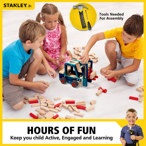 Three children playing with a handcrafted wooden forklift toy kit featuring blue and natural wood tones with red wheels, surrounded by wooden blocks for indoor play and arts and crafts.