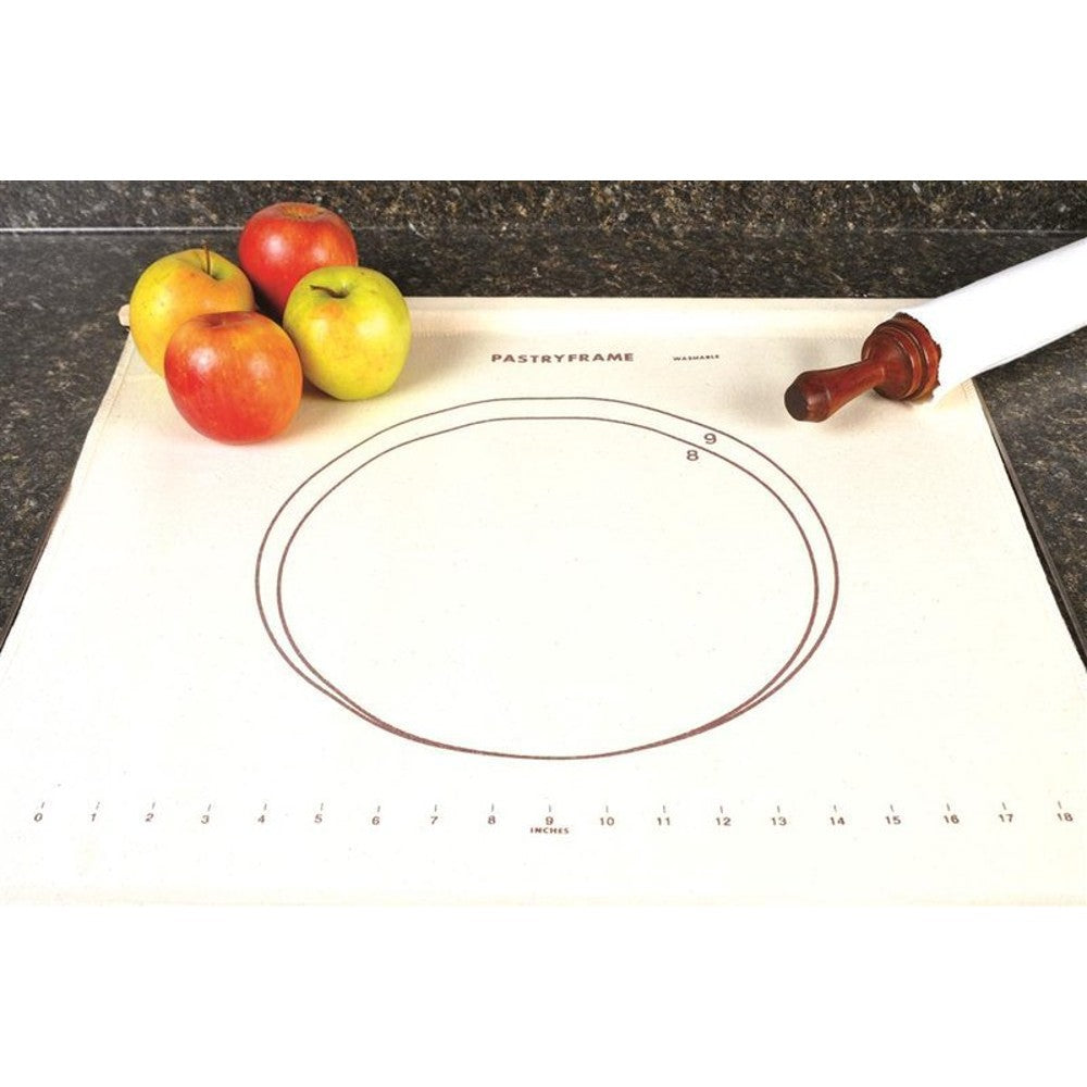 Fabric pastry frame with wooden slats and metal loops holding dough taut on a countertop, featuring size guides, alongside apples and a rolling pin, ideal for Kitchen & Food and Baking Supplies collections.
