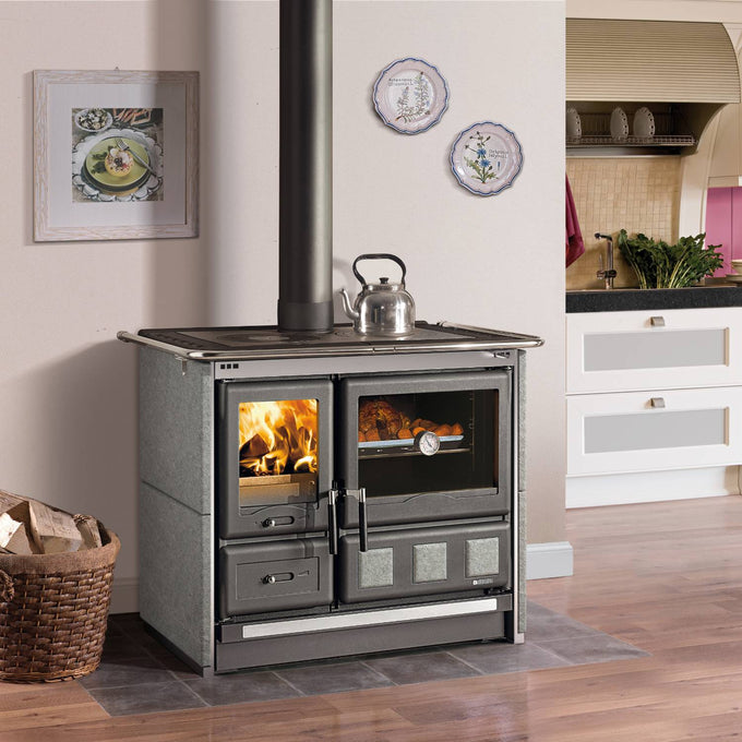 Wood-burning cook stove with porcelain enameled steel oven door, polished cast iron top cooking plates, and extractable ash drawer, set in a kitchen environment, perfect for Stoves and Cookstoves collections.
