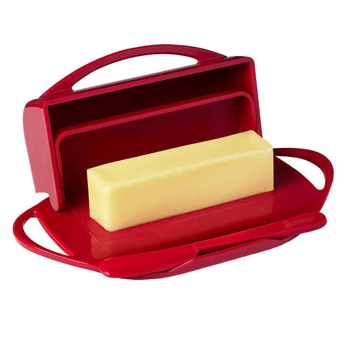 Red flip-top butter dish with matching spreader resting in a specially designed cradle, offering easy, mess-free butter storage and spreading for Kitchen & Food and Kitchen Gadgets collections.