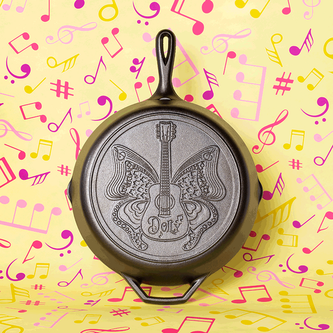 Cast iron skillet featuring an embossed butterfly and guitar design with "Dolly" lettering, handcrafted in the USA, ideal for Kitchen & Food, Cookware, Cast Iron, Best Sellers, and Promo Eligible collections.