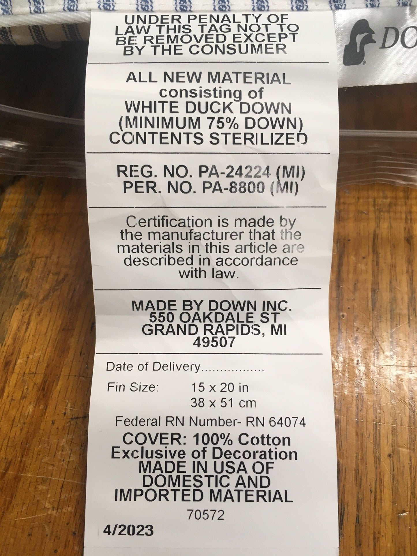 Tag showing pillow fill of white duck down with minimum 75% down, sterilized, in 15x20 inch size with 100% cotton cover, handcrafted in USA, fitting Home & Decor, Home Textiles, Best Sellers collections.