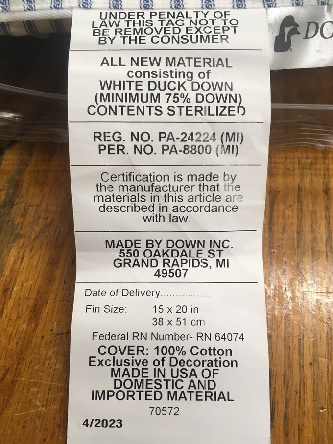 Tag showing pillow fill of white duck down with minimum 75% down, sterilized, in 15x20 inch size with 100% cotton cover, handcrafted in USA, fitting Home & Decor, Home Textiles, Best Sellers collections.