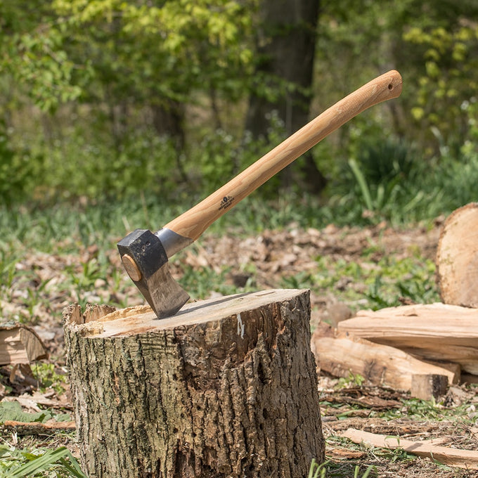 Hand-forged splitting axe with a sharp steel head and smooth wooden handle embedded in a tree stump, ideal for wood cutting and hauling, featured in Farm, Garden & Tool and Axes collections.