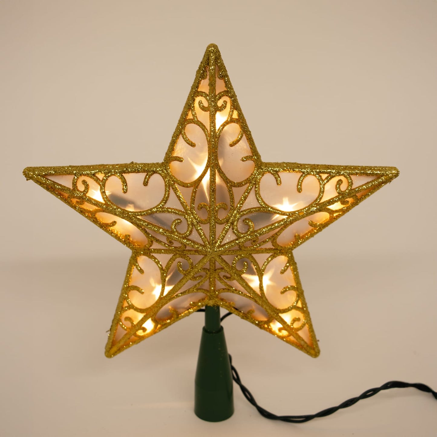 Lighted golden star tree topper with intricate scroll design and built-in warm lights, adding elegant charm to holiday decor, featured in Home & Decor and Best Sellers collections.