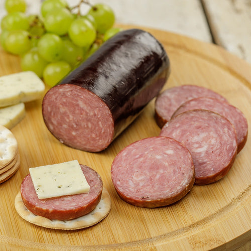Handcrafted summer sausage from Amish Country, sliced on a wooden board with crackers, herb cheese, and green grapes, perfect for Kitchen & Food, Snacks and Sweets, Pantry, Meats, USA Made, and Best Sellers collections.