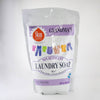 Resealable pouch of natural powdered laundry soap with colorful clothing illustrations, labeled non-detergent and skin safe, designed for gentle cleaning in Laundry Supplies and USA Made collections.