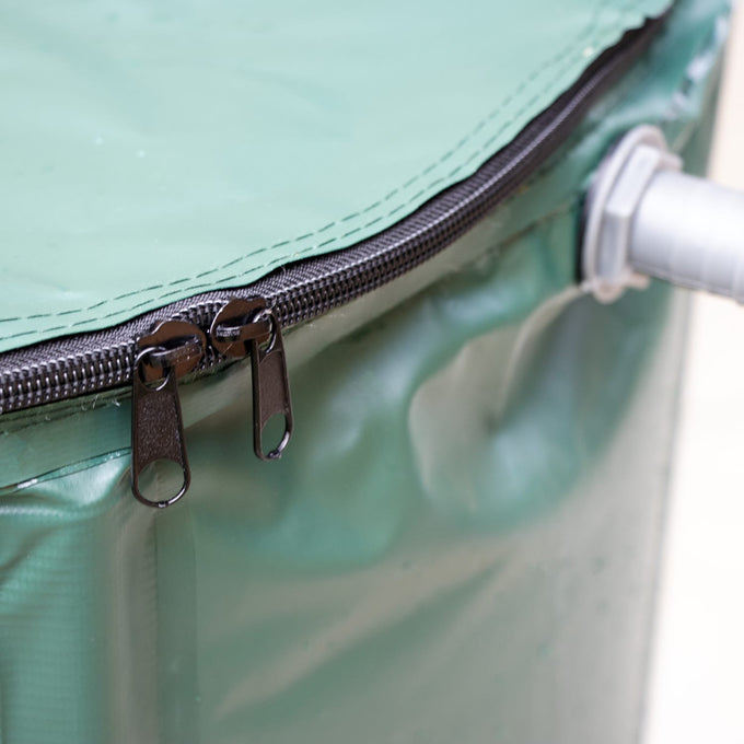 Close-up of a durable green collapsible rain barrel zipper and gray plastic spigot attachment, designed for easy assembly and water collection, featured in Farm, Garden & Tool and Lawncare collections.