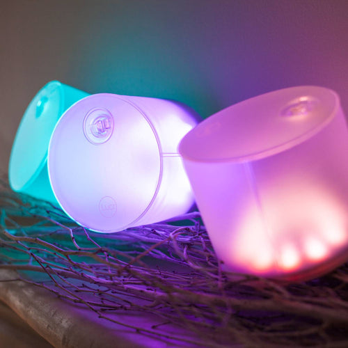 Handcrafted inflatable solar LED lights glowing in soft teal, purple, and pink hues, perfect for eco-friendly use in camping, farm, garden, and emergency lighting collections.