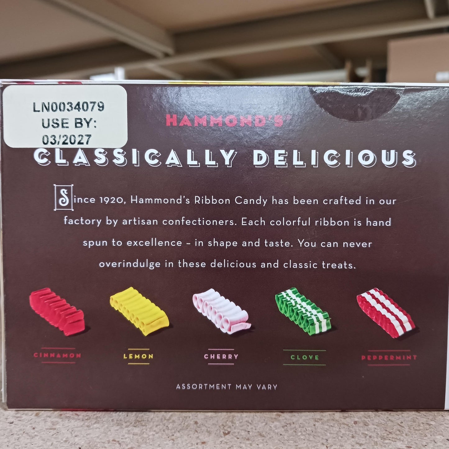 Back of Hammond’s handspun ribbon candy gift box featuring colorful artisan-crafted candy ribbons in cinnamon, lemon, cherry, clove, and peppermint flavors, highlighting USA Made and Snacks and Sweets collections.