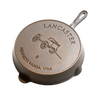 Bottom view of a handcrafted, lightweight cast iron skillet with embossed design of a horse-drawn wagon and the text Pennsylvania, USA, suitable for Kitchen & Food, Cast Iron, and USA Made collections.